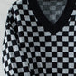 Black and white checkerboard sweater for a modern, laid-back style.
