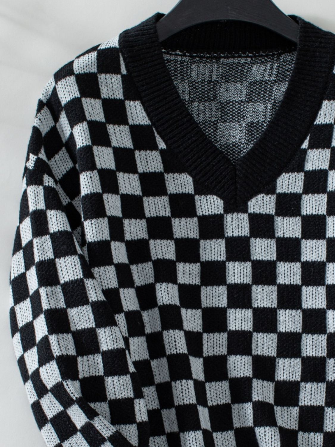 Black and white checkerboard sweater for a modern, laid-back style.
