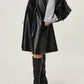 Elegant black leather skirt with high waist and timeless silhouette.
