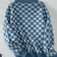 Soft blue and white checkerboard sweater for a chic, modern look.
