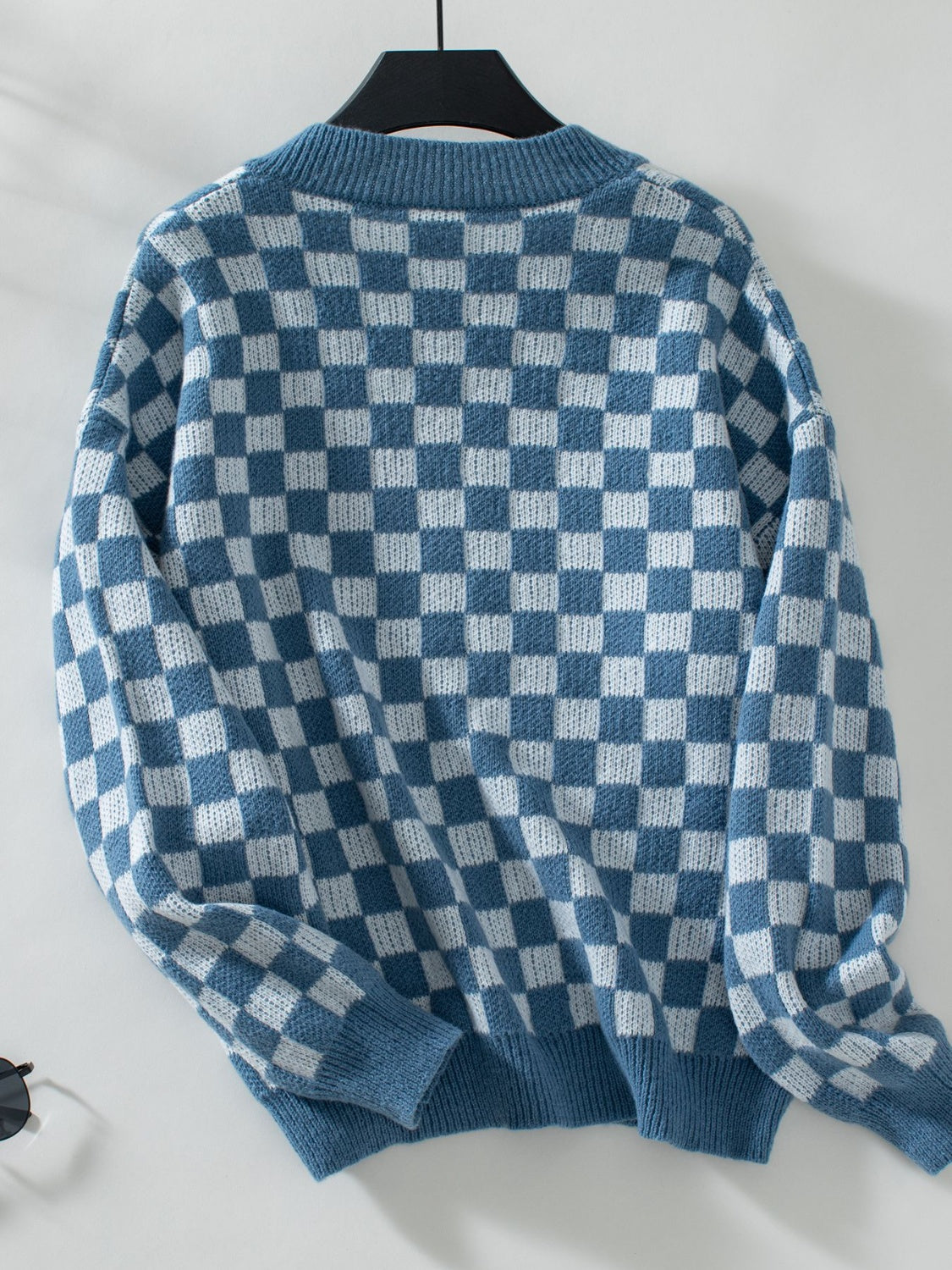 Soft blue and white checkerboard sweater for a chic, modern look.
