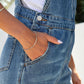 Casual washed blue denim overalls featuring slant pockets for women.
