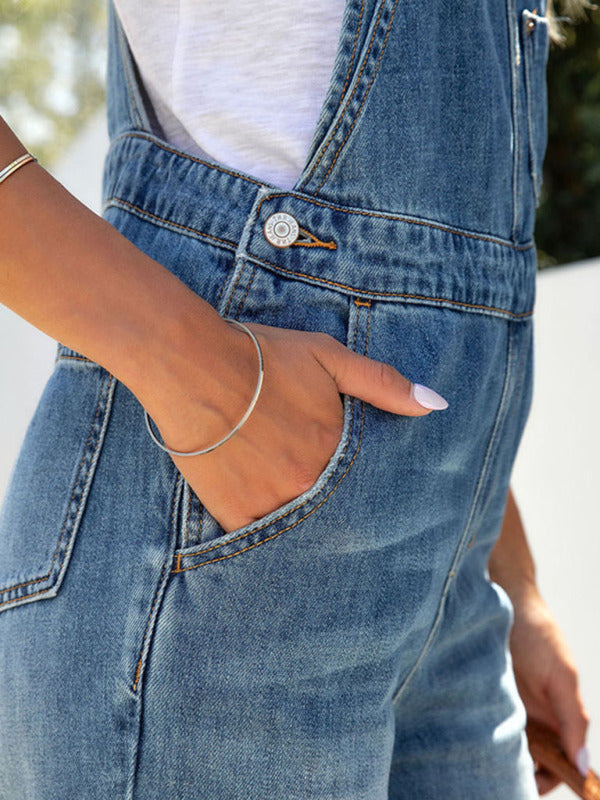 Casual washed blue denim overalls featuring slant pockets for women.
