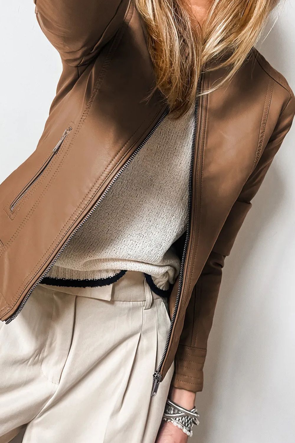 Women's brown pleather jacket, tailored for a sleek silhouette.
