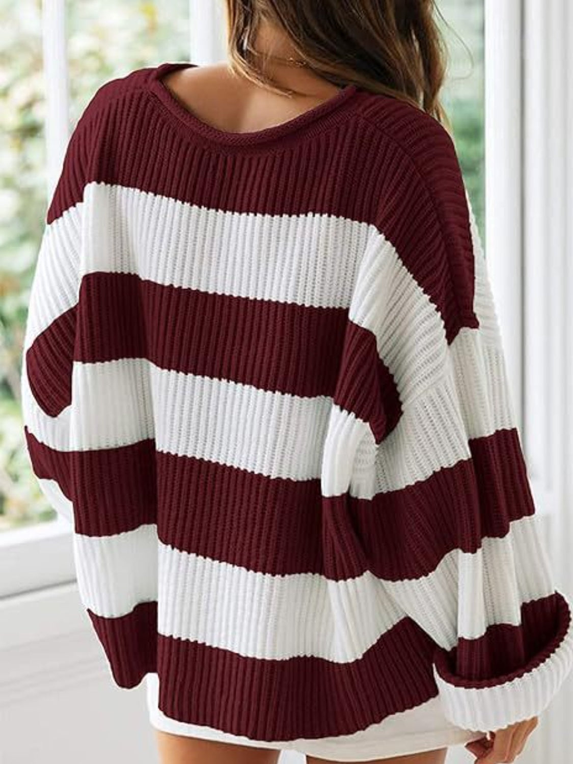 Cozy burgundy striped sweater with bold white stripes for a trendy look.
