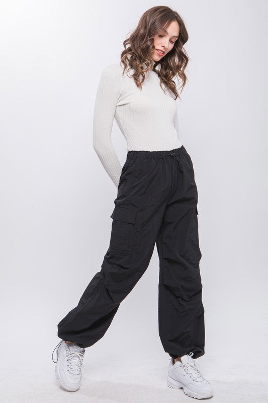 Women’s black cargo pants with a drawstring waist, perfect for casual wear.
