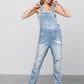 Women’s distressed denim light wash overalls with patch pockets 
