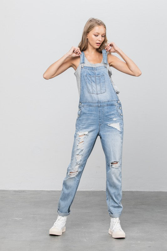 Women’s distressed denim light wash overalls with patch pockets 
