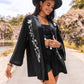 Chic black kimono cardigan with embroidered floral accents for boho look.