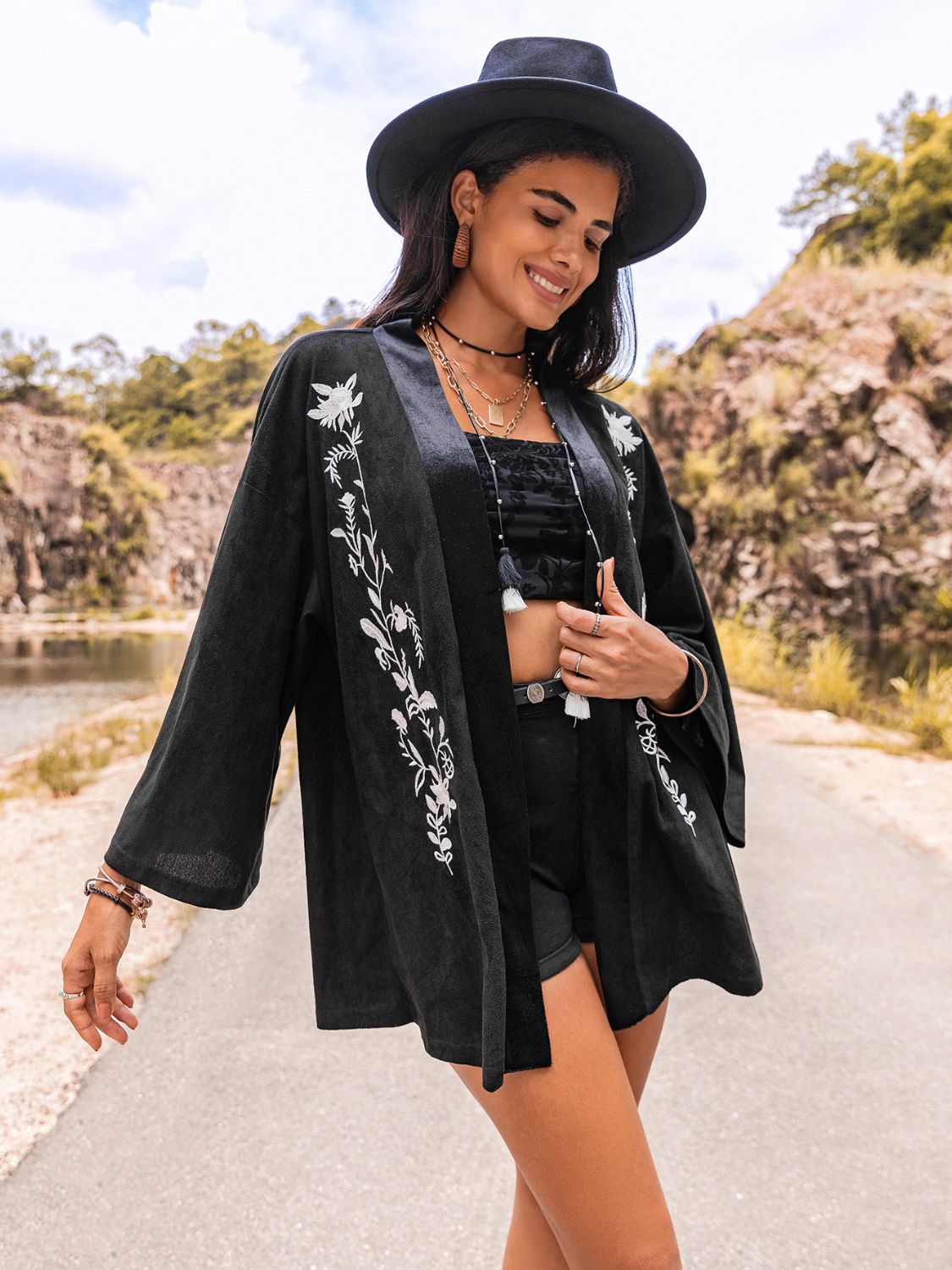 Chic black kimono cardigan with embroidered floral accents for boho look.