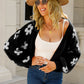 Front view of black floral knit cardigan for women
