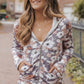 Stylish floral zip-up hoodie paired with jeans for casual wear
