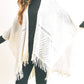 Soft ivory fringe hem shawl styled for a casual layered look.
