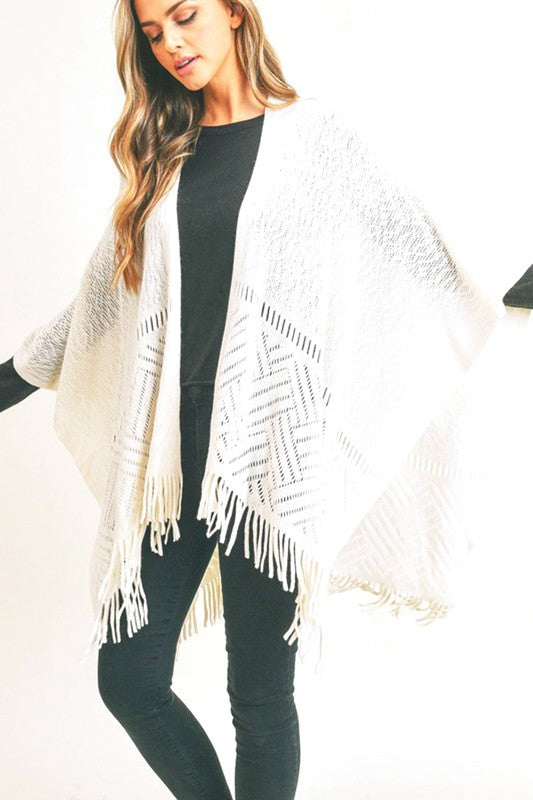 Soft ivory fringe hem shawl styled for a casual layered look.
