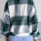 Green plaid collared jacket with button front, styled with a white crop top.
