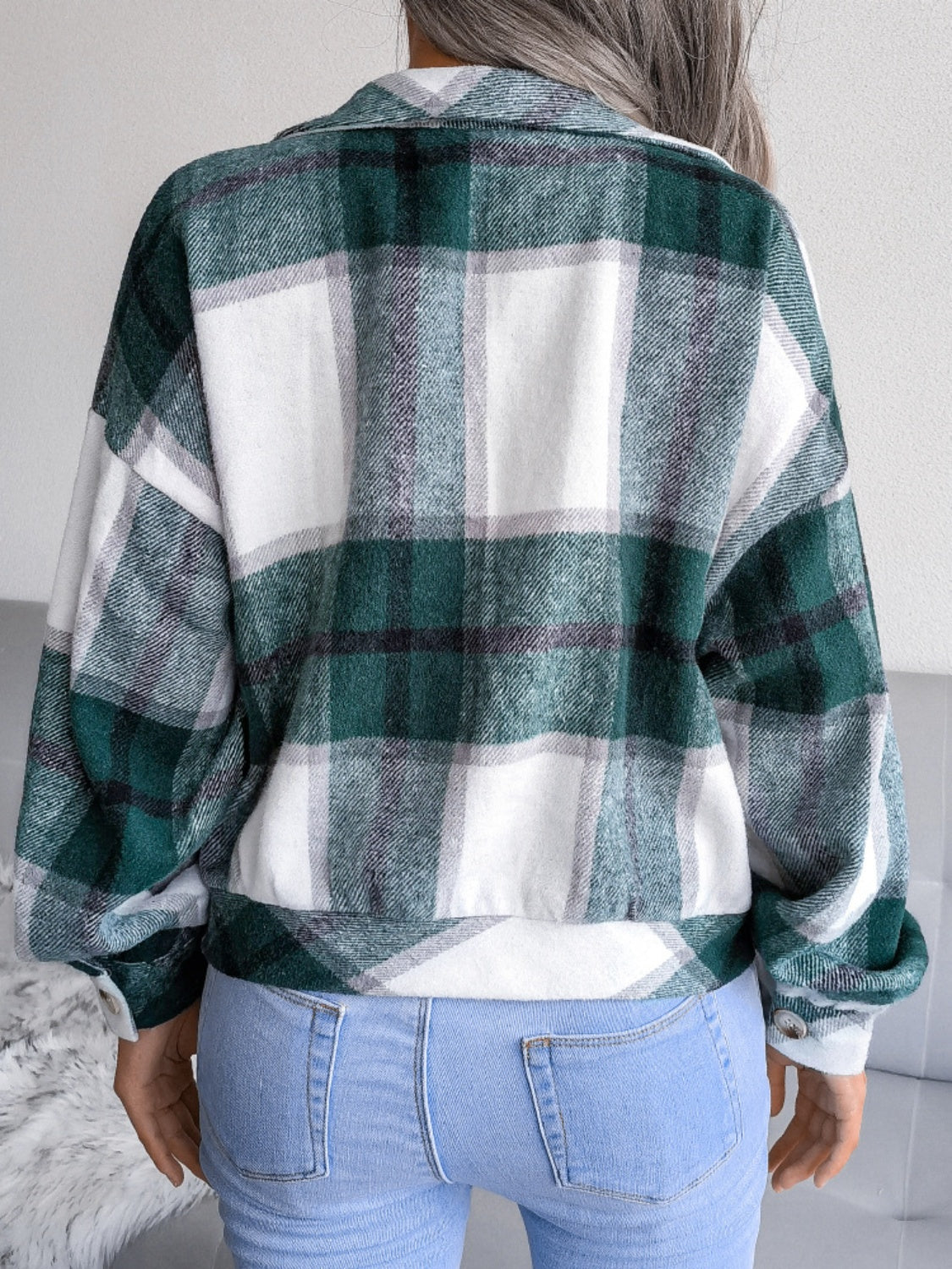 Green plaid collared jacket with button front, styled with a white crop top.
