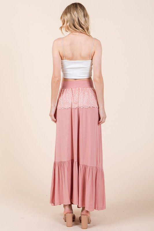 Bohemian-inspired maxi skirt with ruffles and lace detail.
