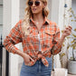 Orange plaid button-up shirt styled with skinny jeans and sunglasses.
