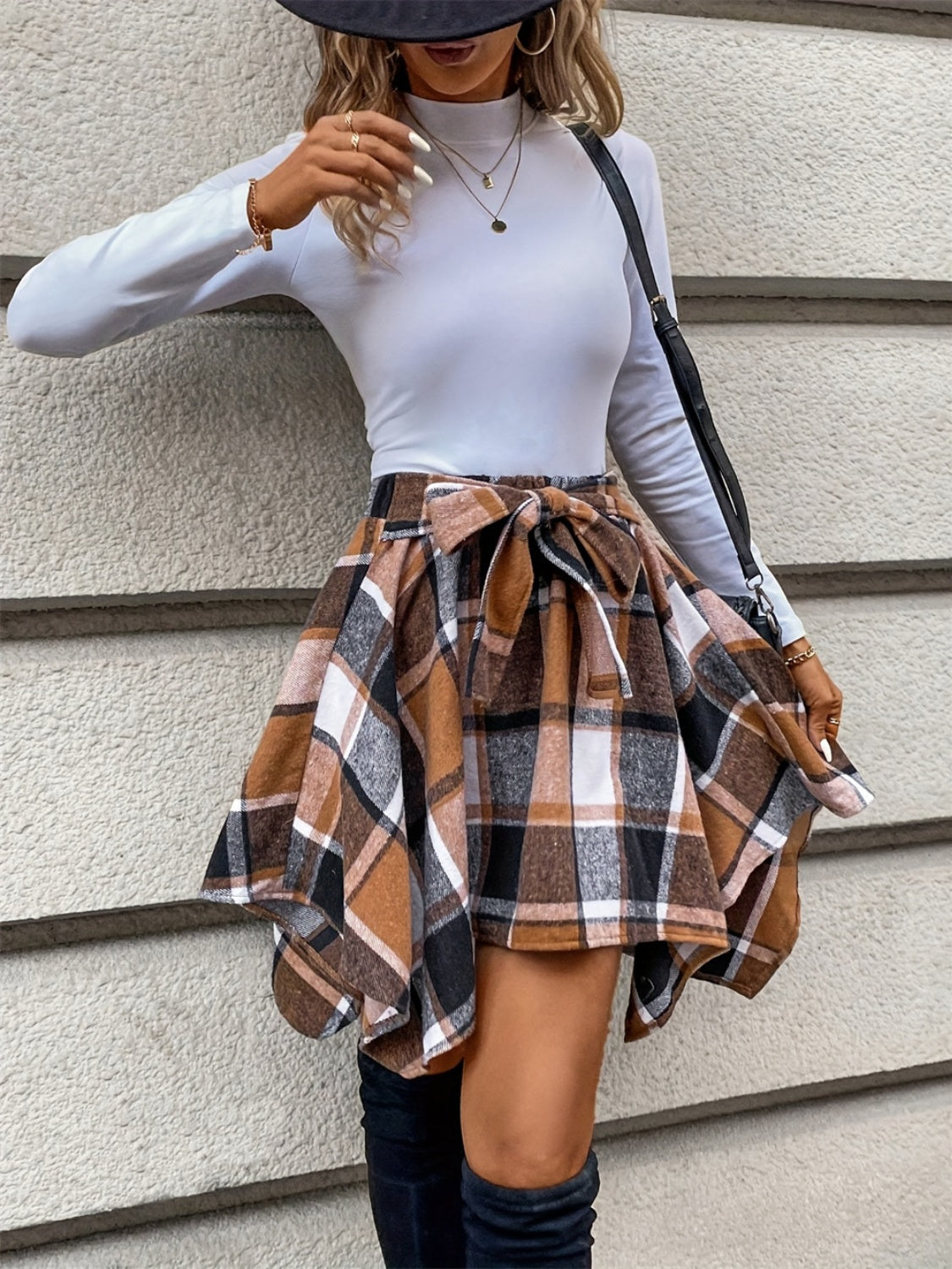 Plaid asymmetrical skirt in caramel, ideal for autumn outfits.
