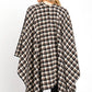 Black plaid wrap shawl styled over simple, comfortable outfit.
