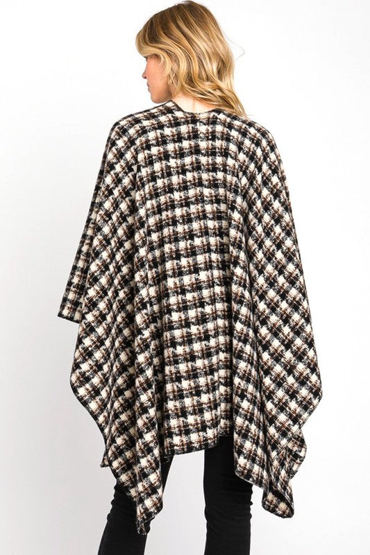 Black plaid wrap shawl styled over simple, comfortable outfit.
