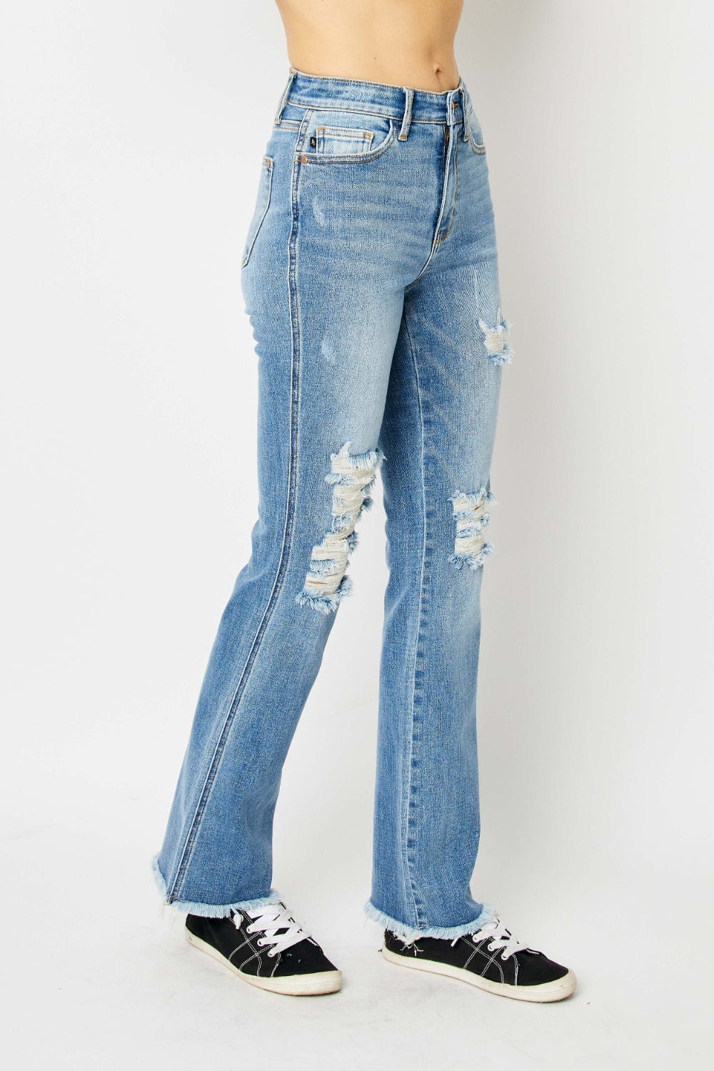 Women's Judy Blue Distressed Raw Hem Bootcut Jeans with soft and stretchy fabric for comfort.