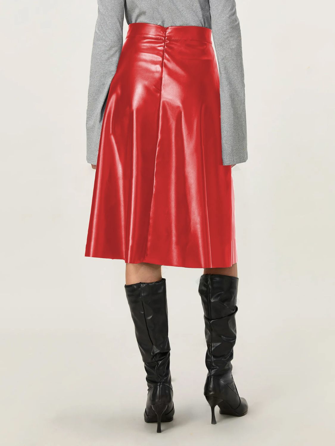 Bold red leather skirt in an A-line style, ideal for day-to-night outfits.
