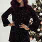 Black sequin party dress with bell sleeves and back bow.
