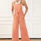 Lightweight pocketed wide-leg overalls featuring a relaxed and adjustable fit.
