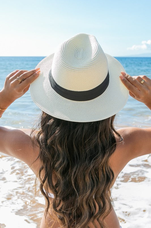 Classic beach-ready straw fedora with a black accent band.
