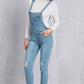 Women’s trendy washed denim overalls with mid-waist design and ripped knees.
