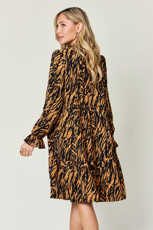 Lightweight animal print dress with elastic cuffs and a flowy fit.
