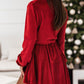 Model wearing red velvet tie-waist dress, perfect for festive gatherings.
