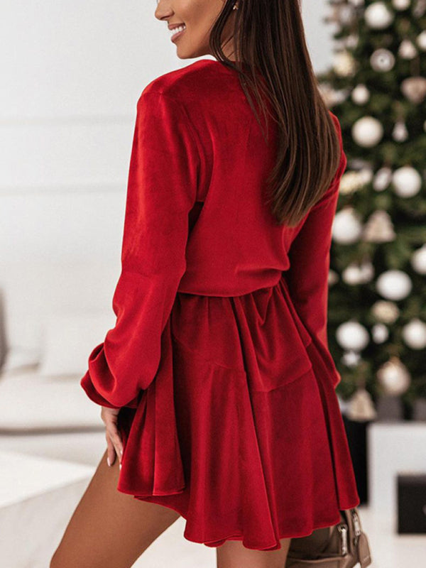 Model wearing red velvet tie-waist dress, perfect for festive gatherings.
