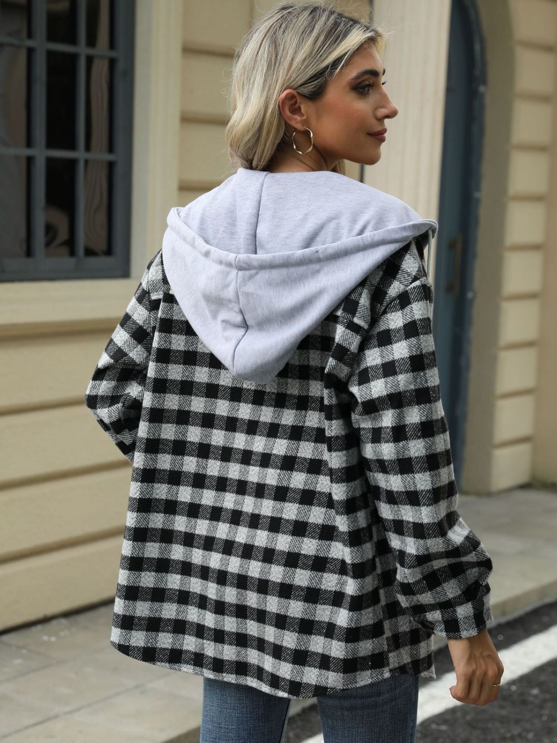 Button-up black plaid jacket with hood, styled for a chic fall look
