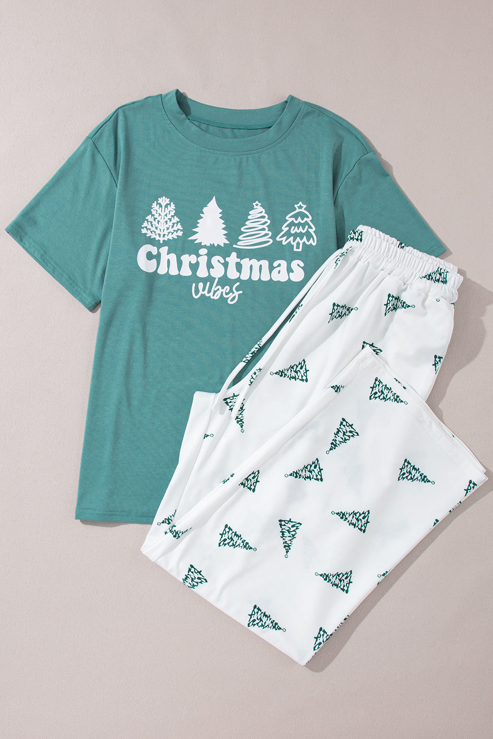 Festive Christmas vibes graphic tee and matching tree print pants for women.
