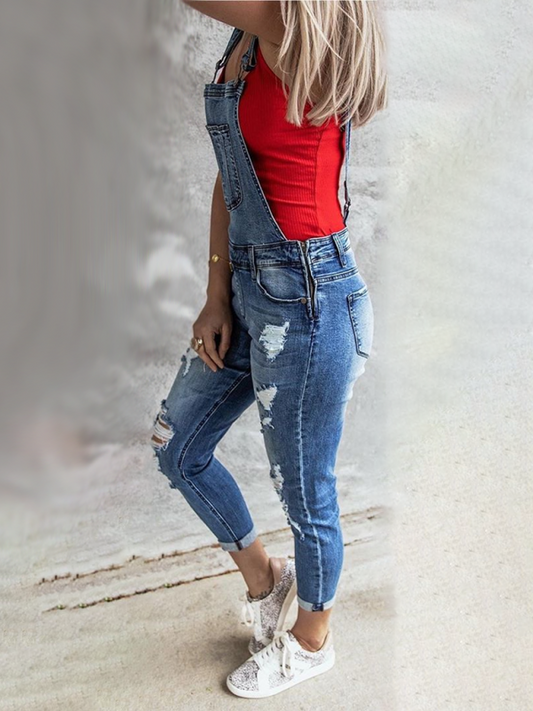 Distressed denim overalls with rolled cuffs for a laid-back look.