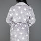 Woman in a gray star-patterned plush robe, showcasing the soft fabric and loose fit.
