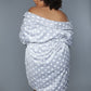 Close-up of a gray polka dot plush robe, highlighting the soft fabric and loose fit.
