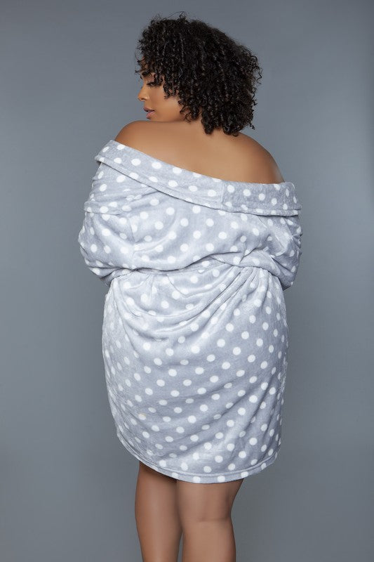 Close-up of a gray polka dot plush robe, highlighting the soft fabric and loose fit.
