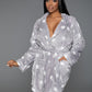 Soft gray plush robe with a star pattern, shown with front patch pockets and cozy fit.
