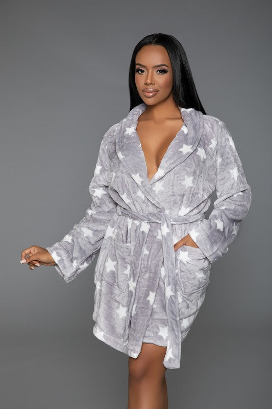 Soft gray plush robe with a star pattern, shown with front patch pockets and cozy fit.
