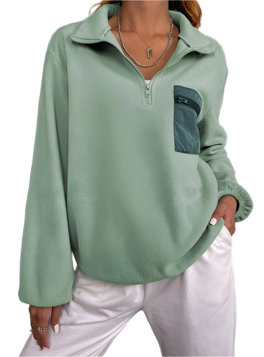 Woman wearing a sage green women's half zip pullover sweatshirt
