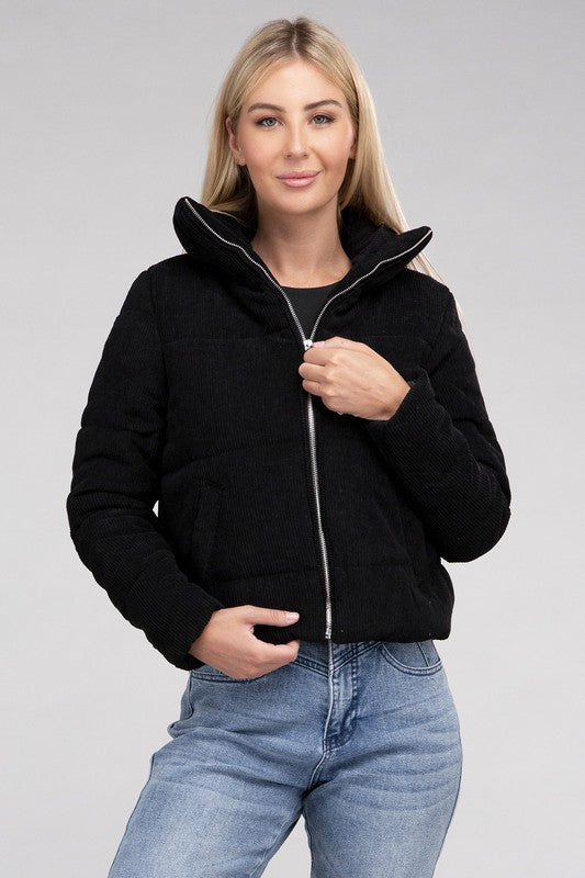 Close-up of a women’s black corduroy jacket featuring a zip-up front and high collar for cozy styling.
