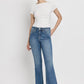 Women's high-rise flare jeans by VERVET with a trendy slant hem.
