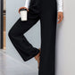 Women's high waisted straight leg pants in black, featuring a tailored fit and stylish belt.
