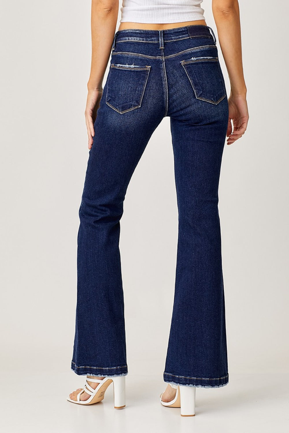 Women's low rise flared denim jeans in dark wash, perfect for casual wear.
