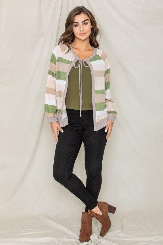 Olive cardigan featuring a tie-front design and colorful striped pattern.