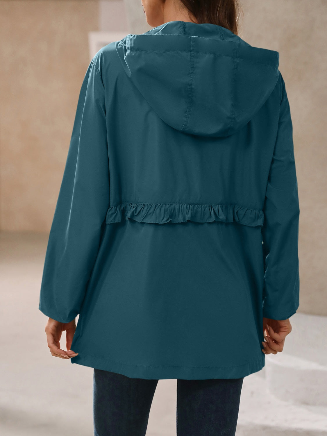 Turquoise womens waterproof rain jacket with hood, perfect for staying dry.
