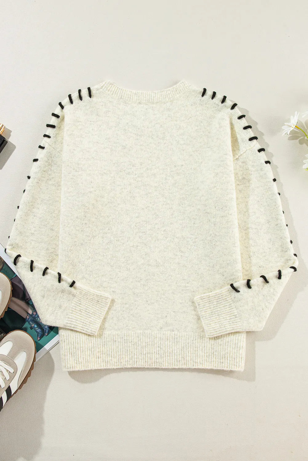 Relaxed-fit beige sweater with stitch detail, perfect for casual autumn looks.
